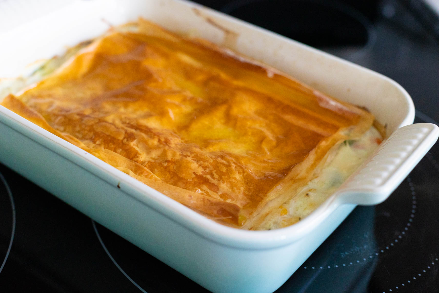 The golden brown phyllo dough is on top of the chicken pot pie fresh from the oven.