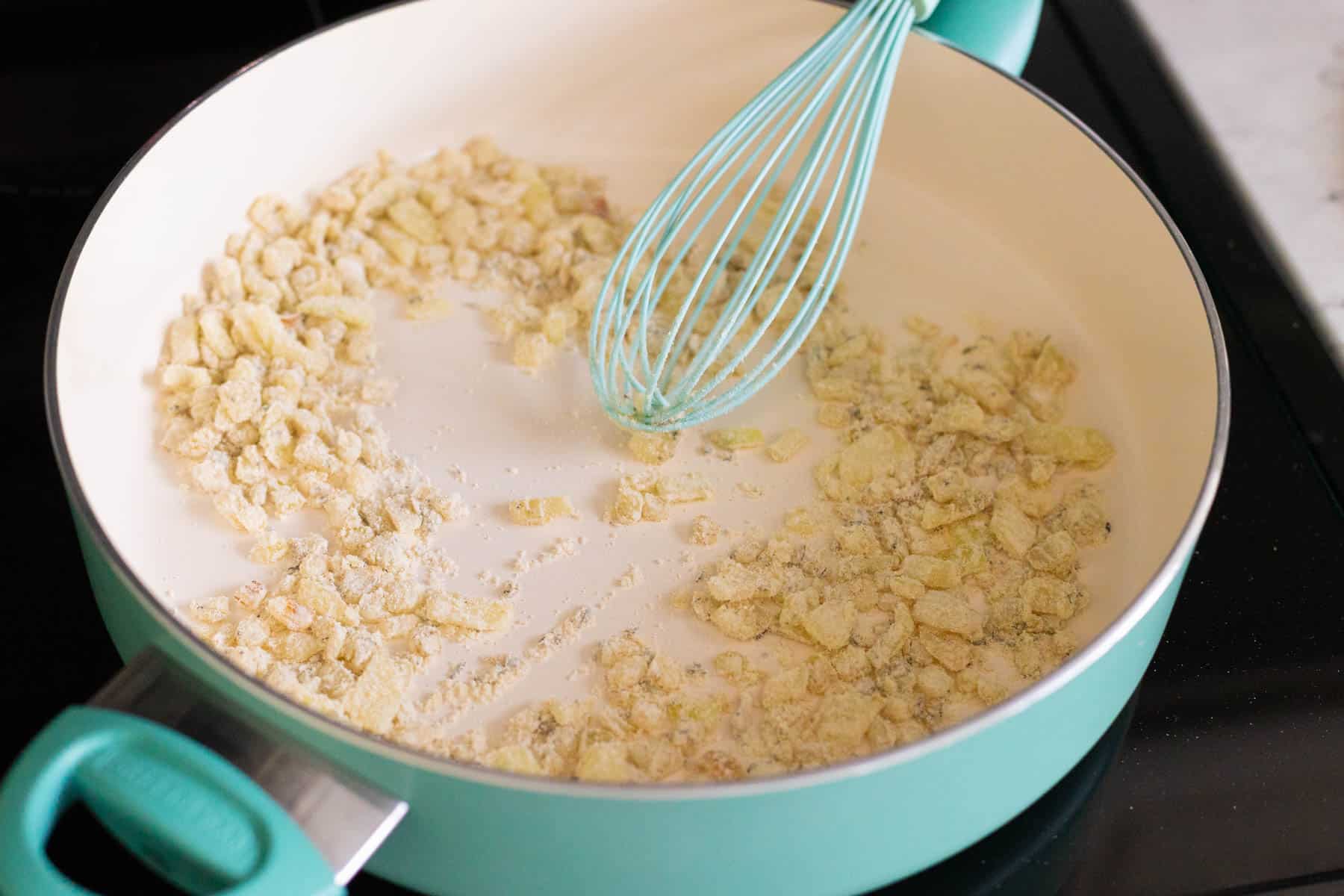 The flour has been stirred into the onions.