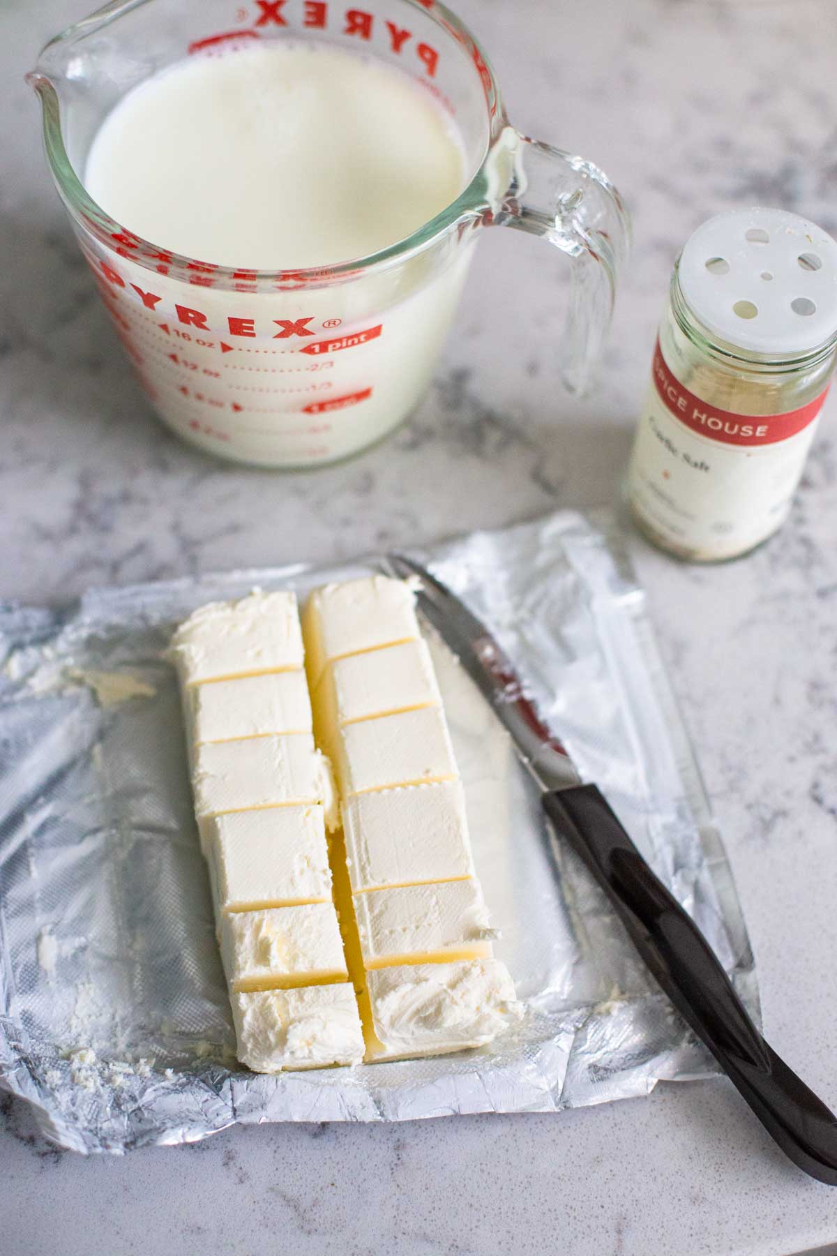 The brick of cream cheese has been cut into smaller cubes for easy melting in the sauce.