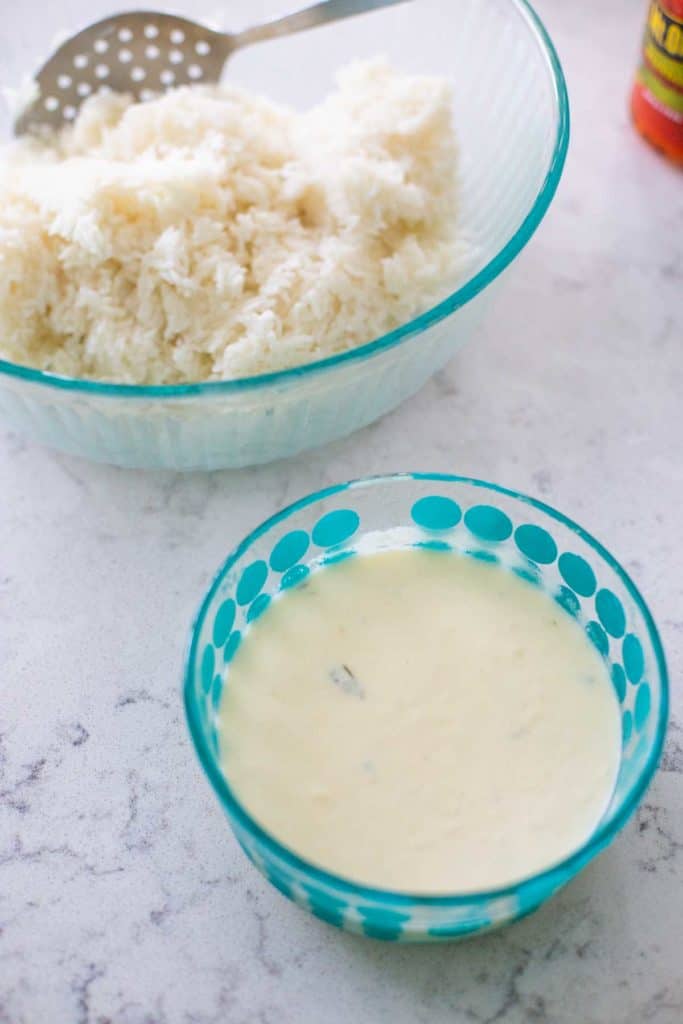 A bowl of homemade alfredo sauce is waiting by the rice. 