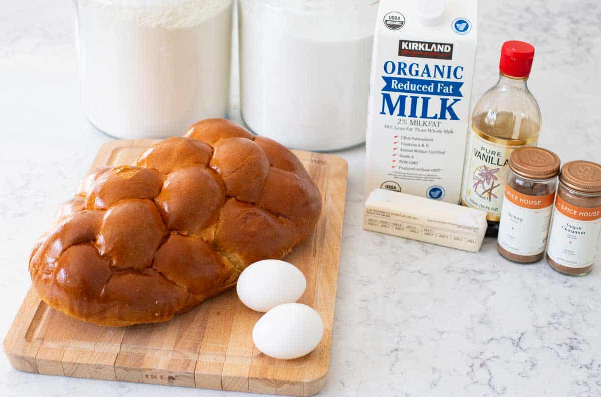 The challah bread sits next to eggs, milk, butter, and the batter seasonings.