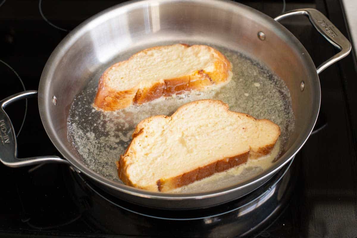 2 large pieces of challah bread fill the griddle pan.