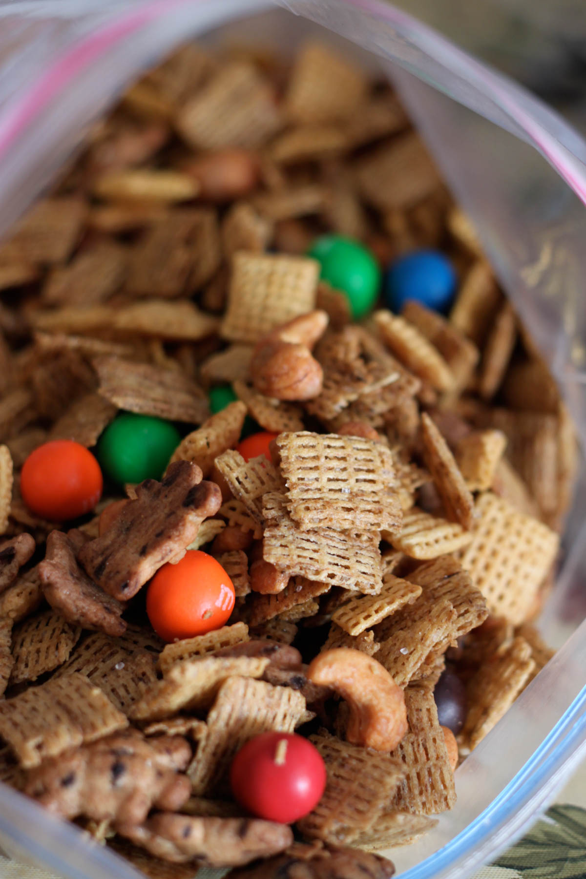 The Chex mix is stored in a plastic zip top bag. You can see all the different mix ins including colorful M&M candies.