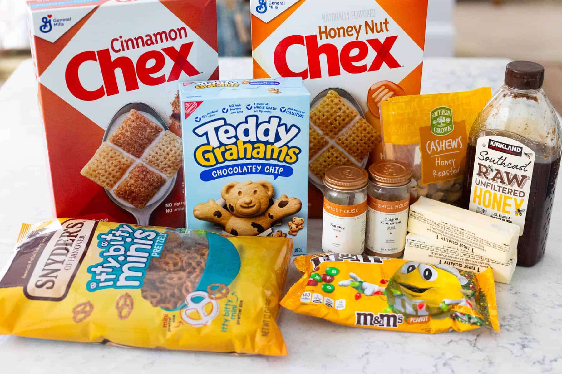 The ingredients to make the homemade Chex Mix are on the counter.