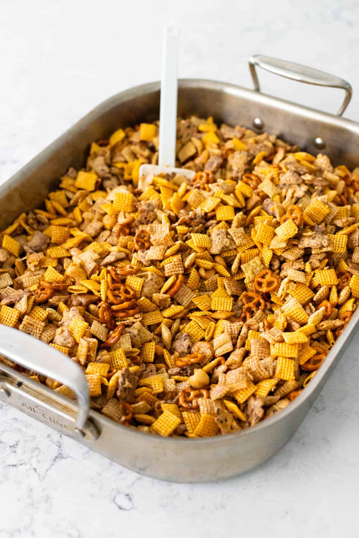 The snack mix has been stirred together with the melted butter.