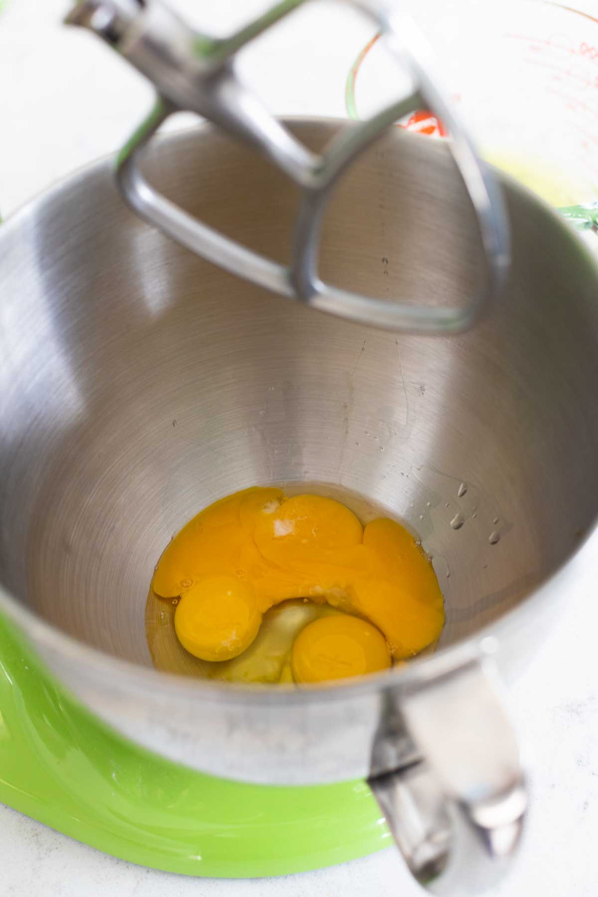Egg yolks and sugar in a mixing bowl.