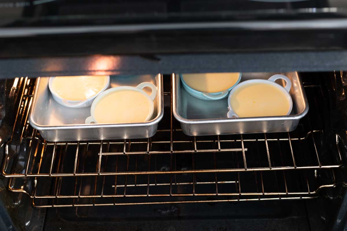 The pans are placed in the oven carefully, side by side.