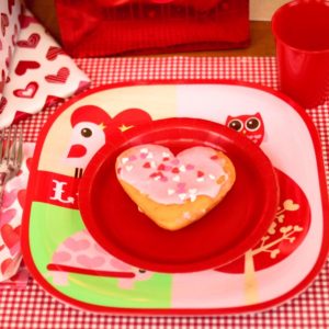 Breakfast for dinner party features heart-shaped donuts.
