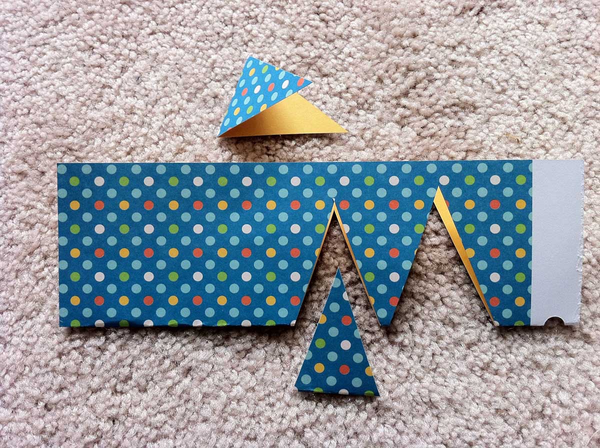 Triangles have been cut from the cardstock with the paper fold forming the base of the triangle.