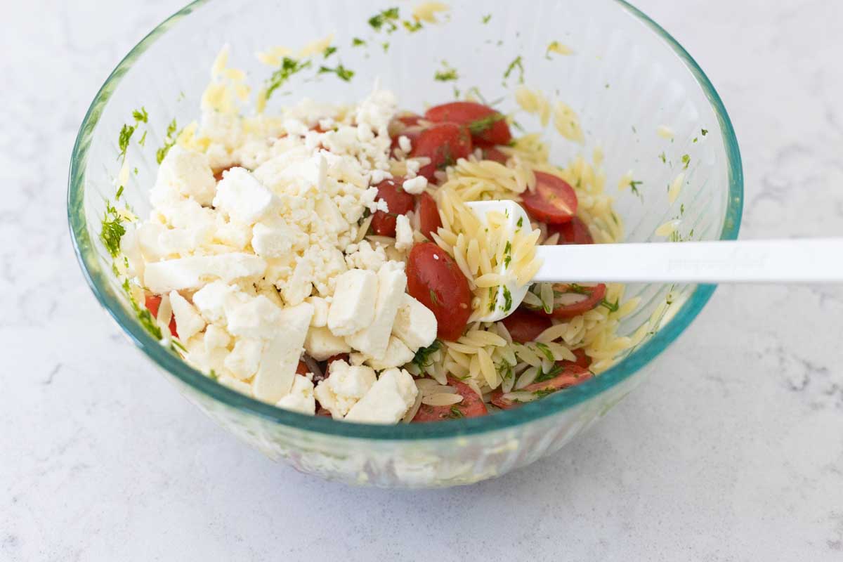 The feta cheese has been added to the bowl to melt in a little bit.