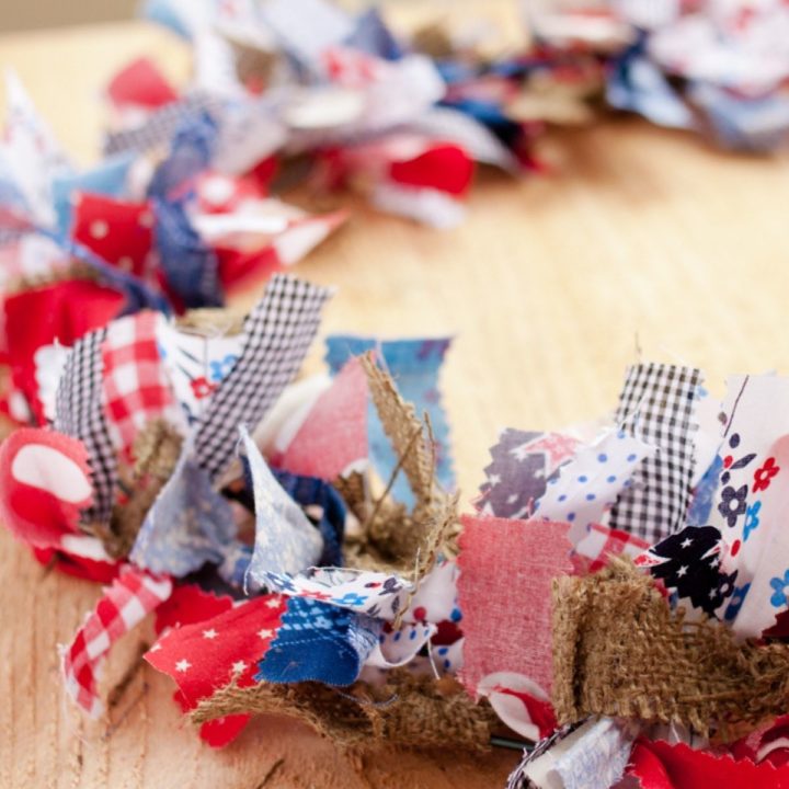 Red, white, and blue fabrics mixed with burlap to make a vintage looking rag wreath.