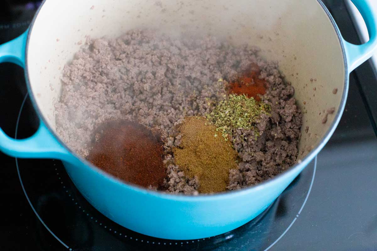 The ground beef has been browned and all the seasonings placed on top.