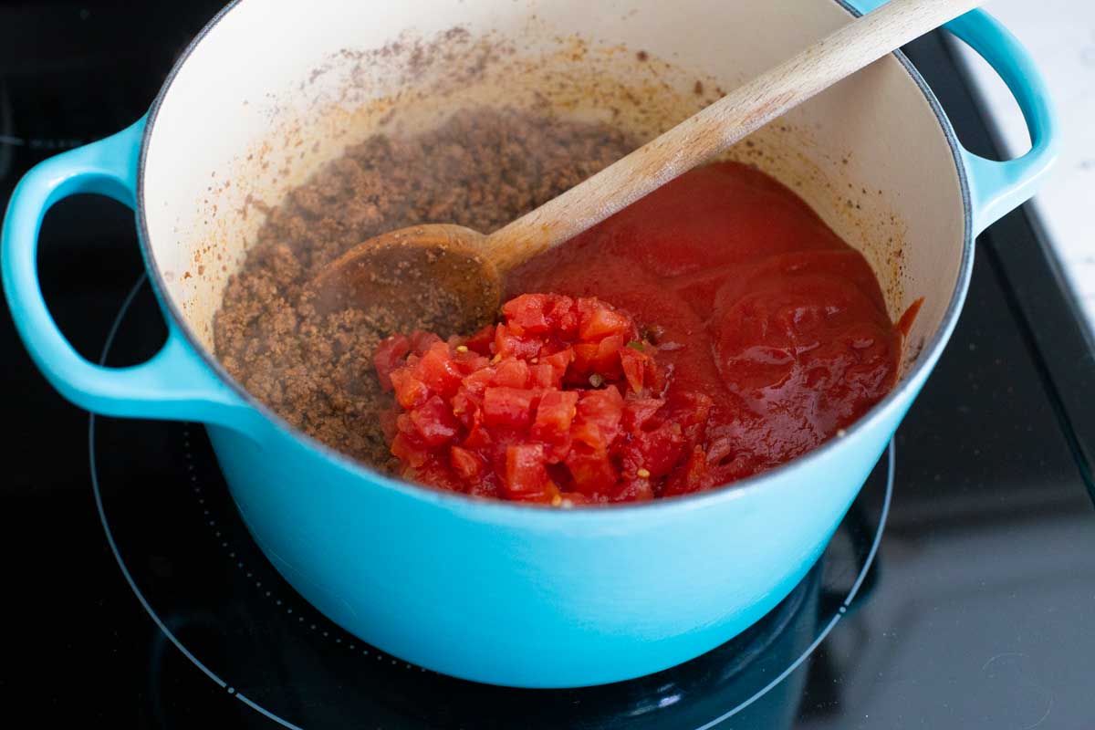 The canned tomato sauce and Rotel diced tomatoes have been added to the pot.