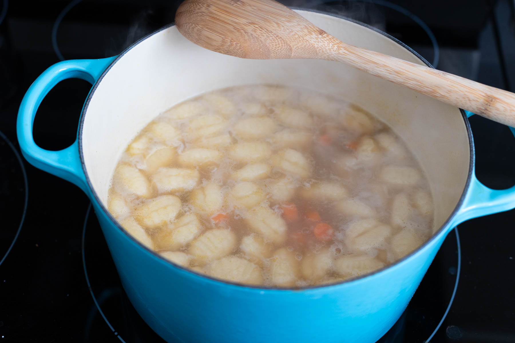 The gnocchi have floated to the top of the soup.