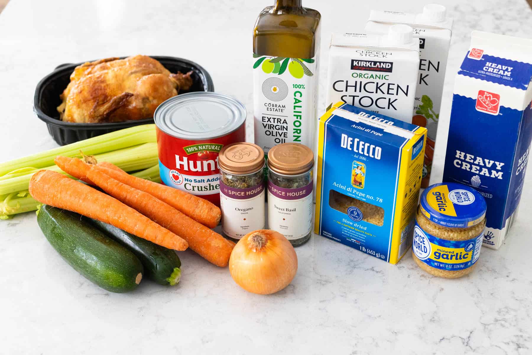 The ingredients to make a homemade Tuscan chicken soup are on the counter.