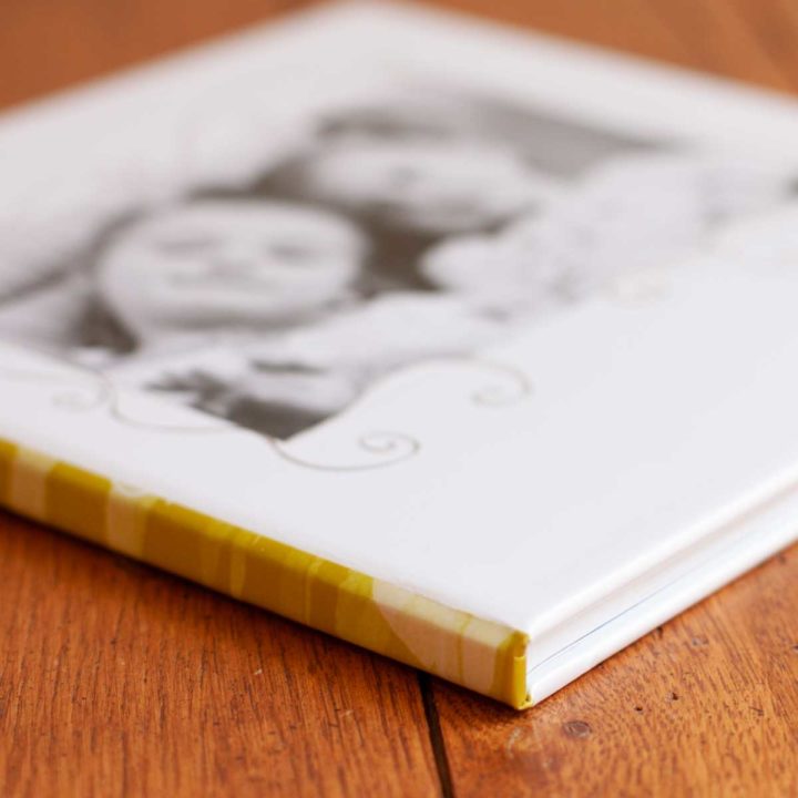 A DIY photobook is on a coffee table.