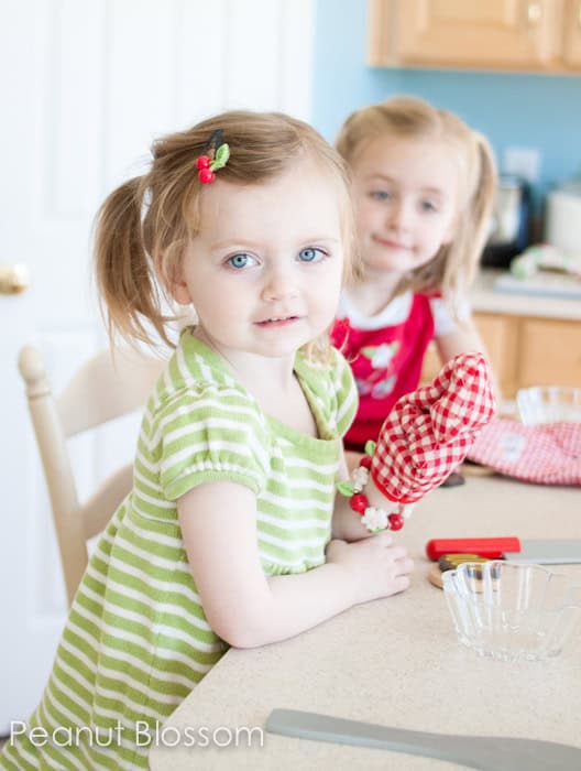 Two little girls ready for holiday baking fun in the kitchen.