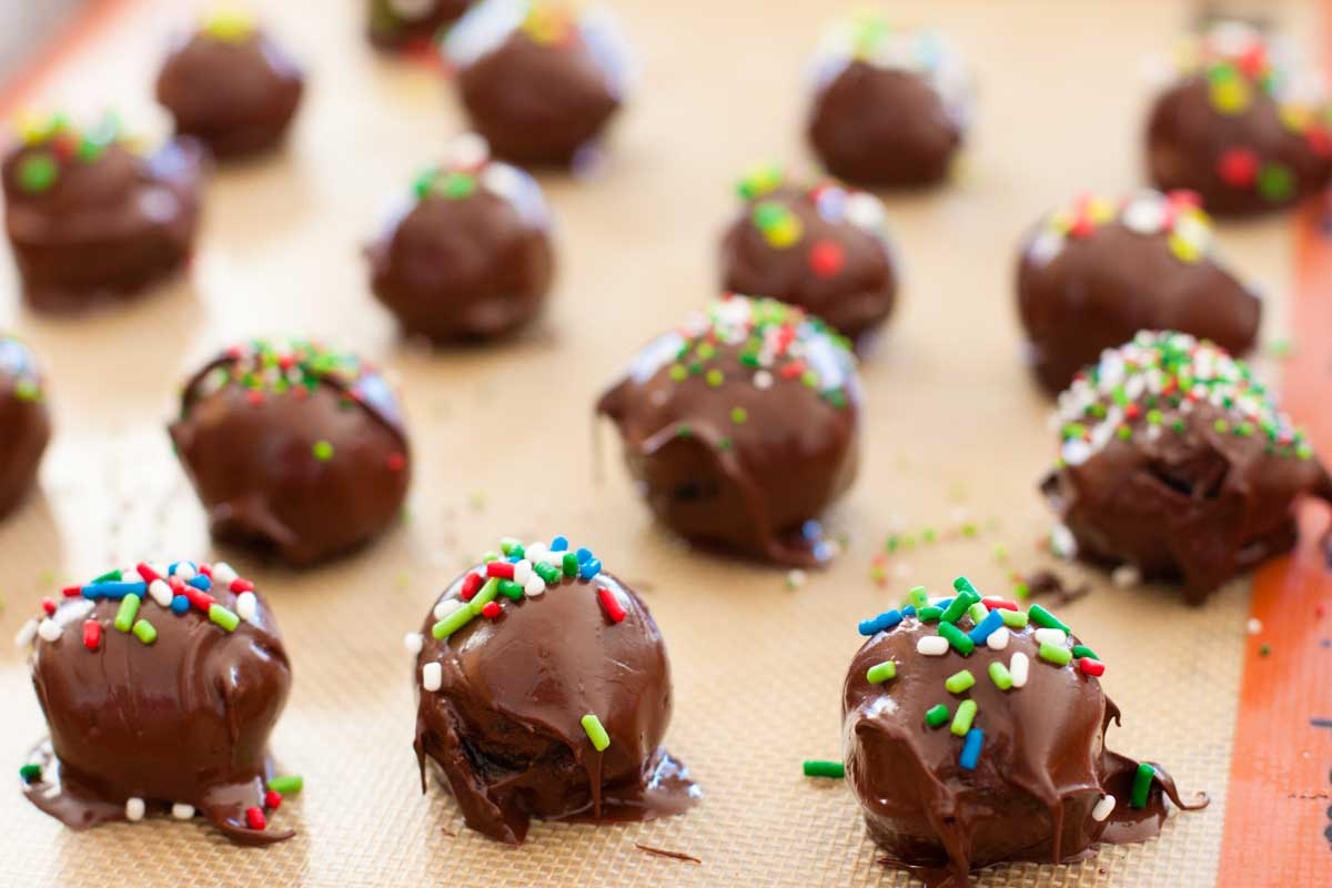 The oreo truffles have festive green and red sprinkles on top.