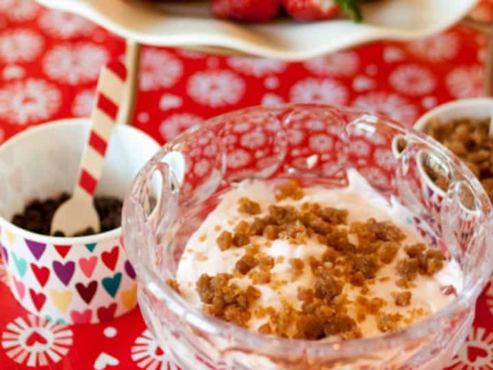 A bowl of strawberry dip with graham crumbled over the top.