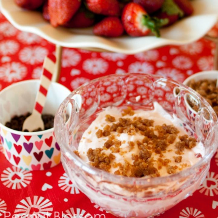 A bowl of strawberry dip with graham crumbled over the top.