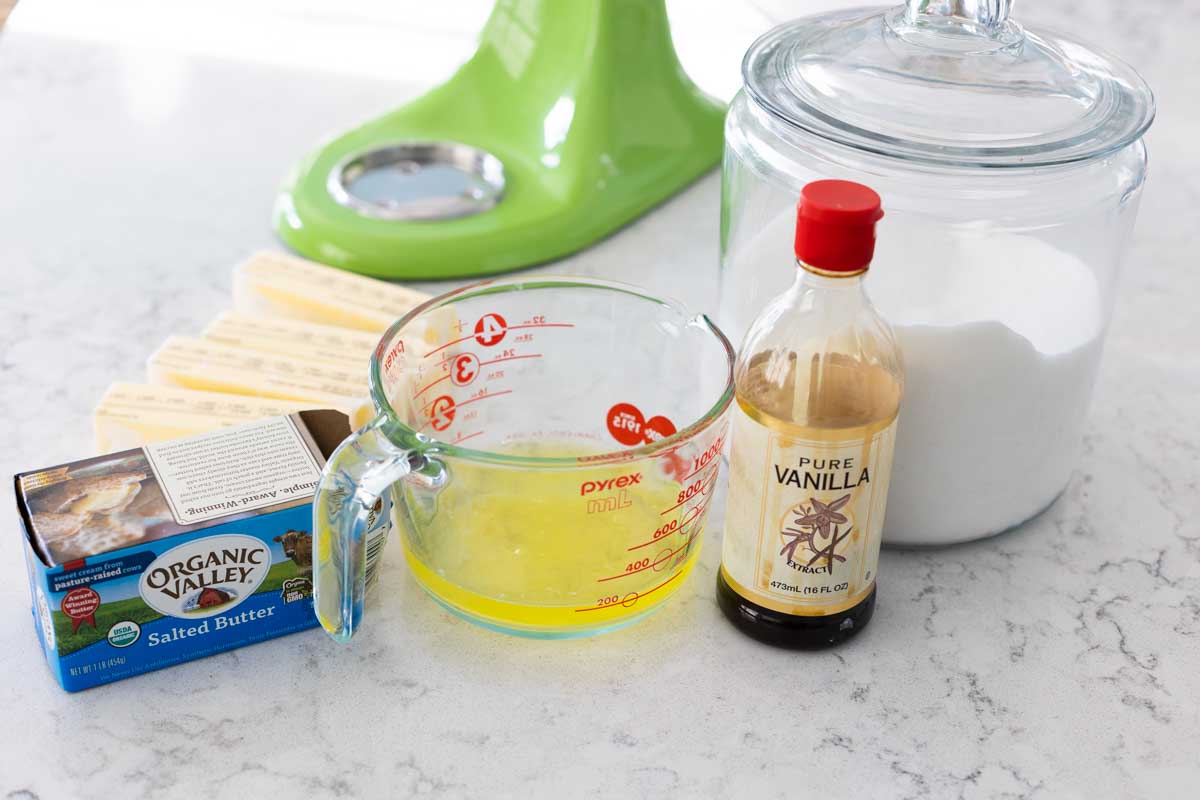 The ingredients to make a homemade Swiss meringue buttercream frosting are on the counter.
