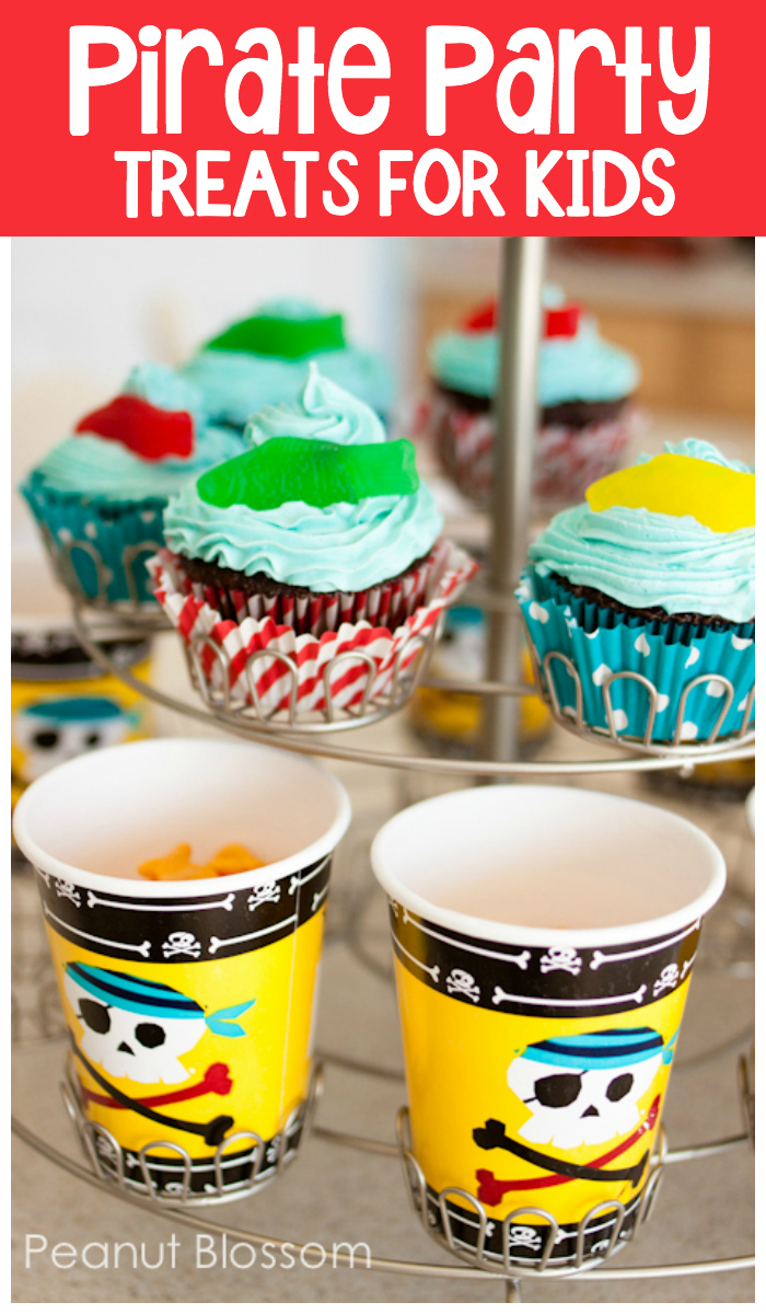 Pirate Party Treats for Kids include Swedish fish swimming on blue frosted cupcakes and Goldfish crackers in pirate cups