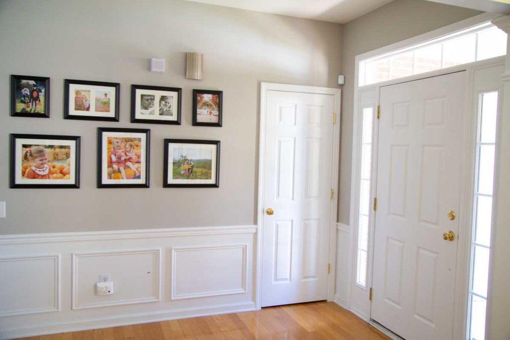 The after photo of the entryway shows a photo gallery near the front door.