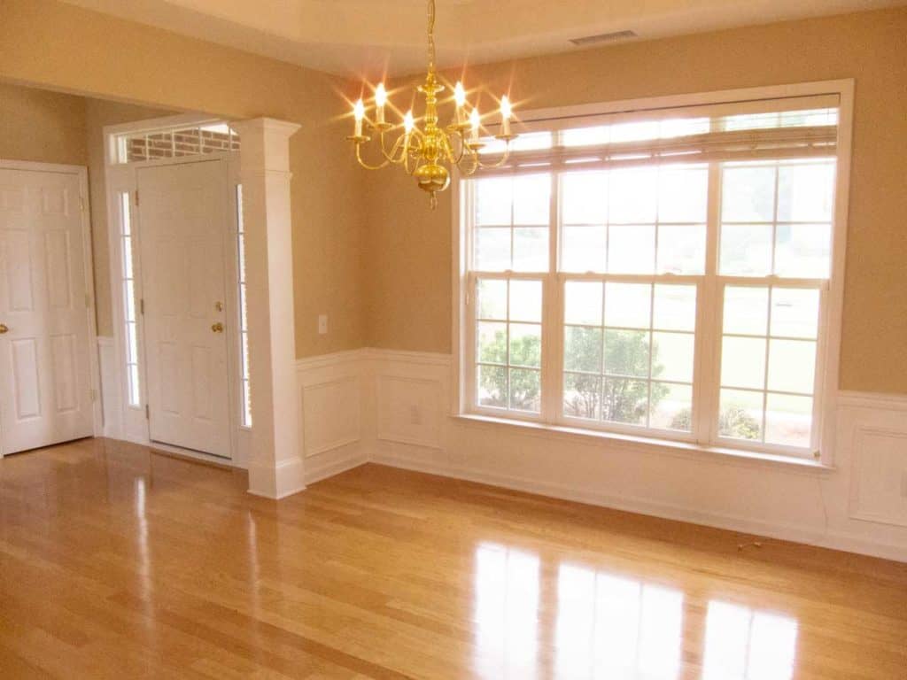 The before picture of a dining room entryway near the front door.