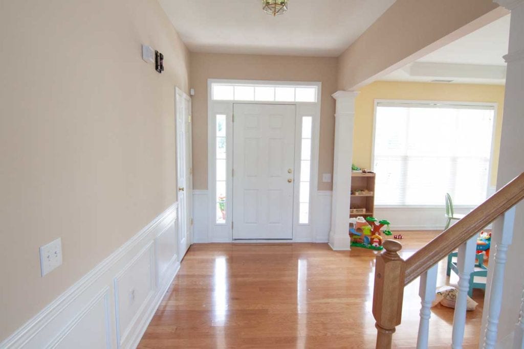 The before picture of the diningroom entryway heading towards the front door.