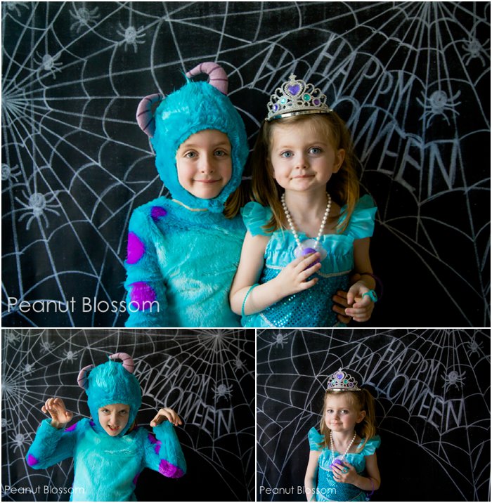 Two girls pose for Halloween costume photos in front of a black backdrop.