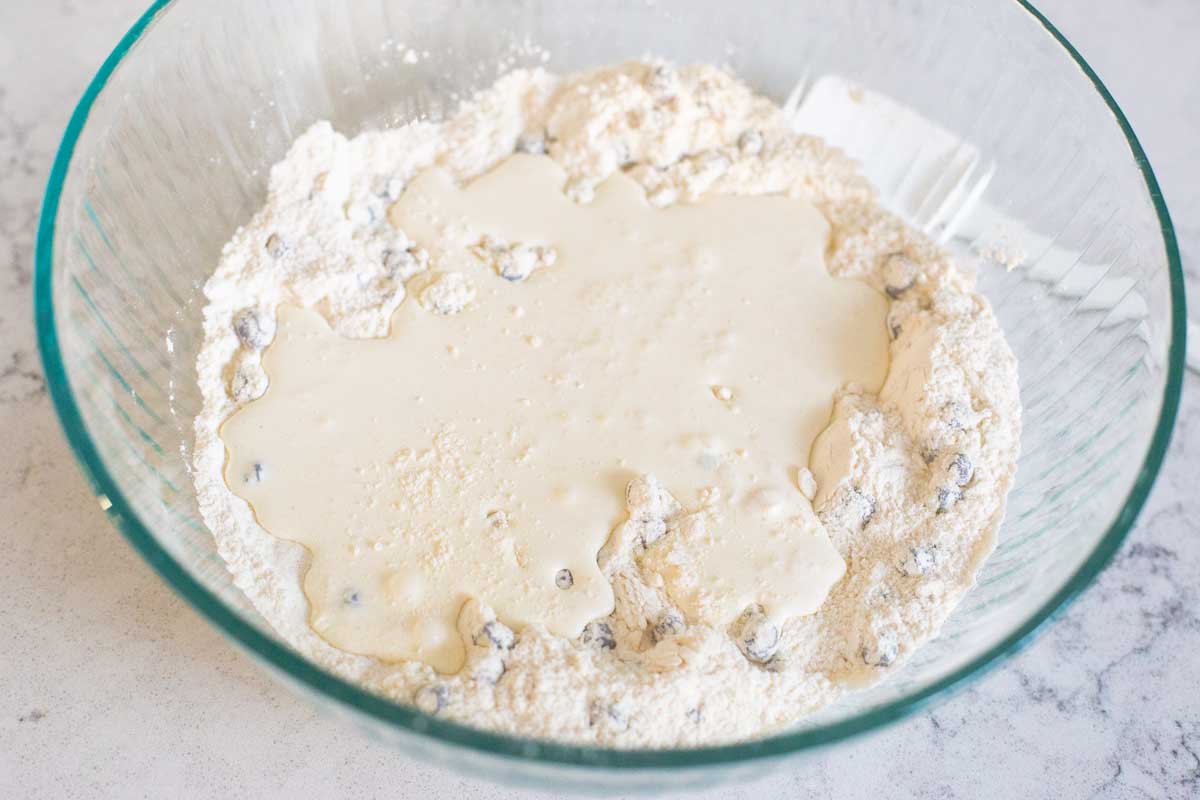 The heavy cream has been poured into the scone mix.