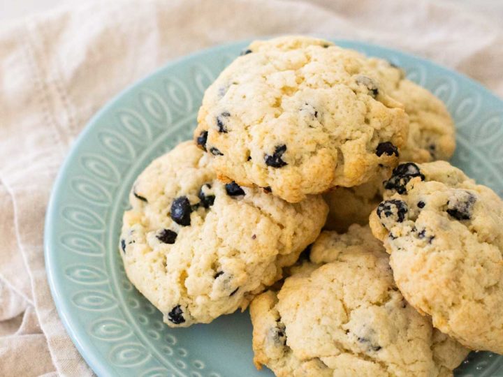 A blue plate has a pile of homemade blueberry scones on top.