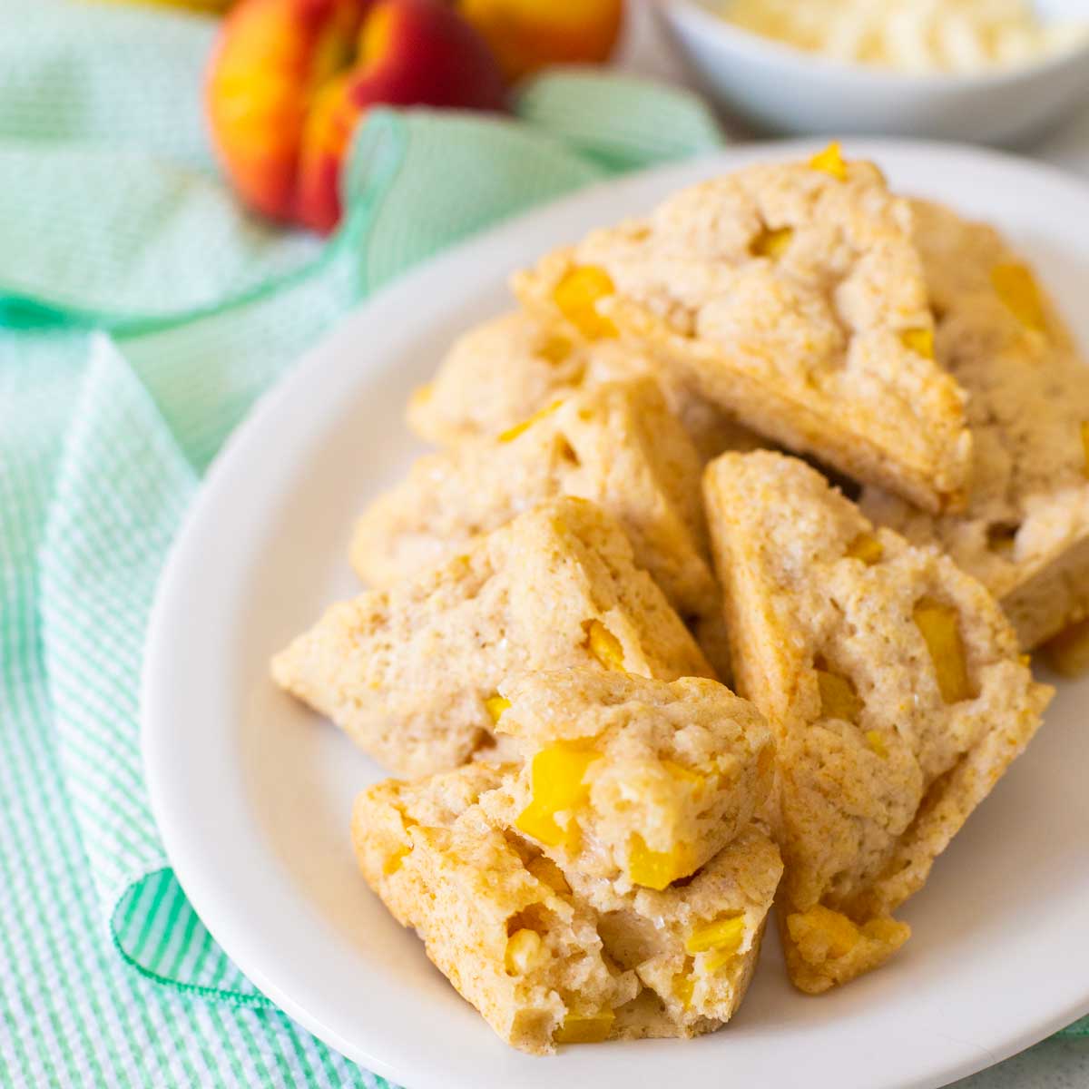 A plate of triangle shaped fresh peach scones.