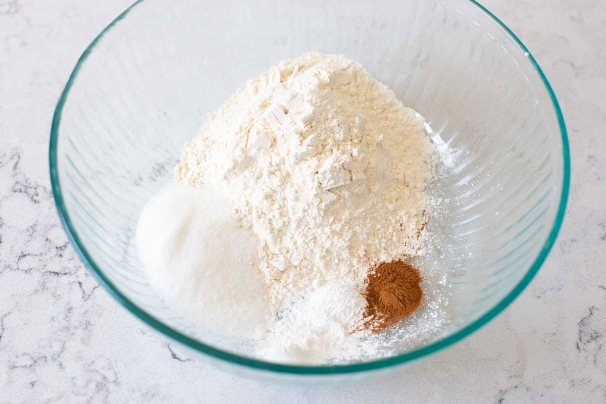 The flour, sugar, baking powder, cinnamon and salt are ready to be whisked together.