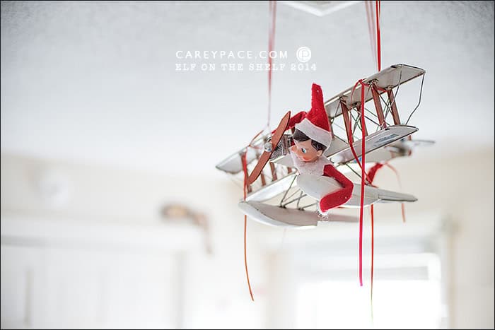 Elf on the Shelf flies airplane by Carey Pace