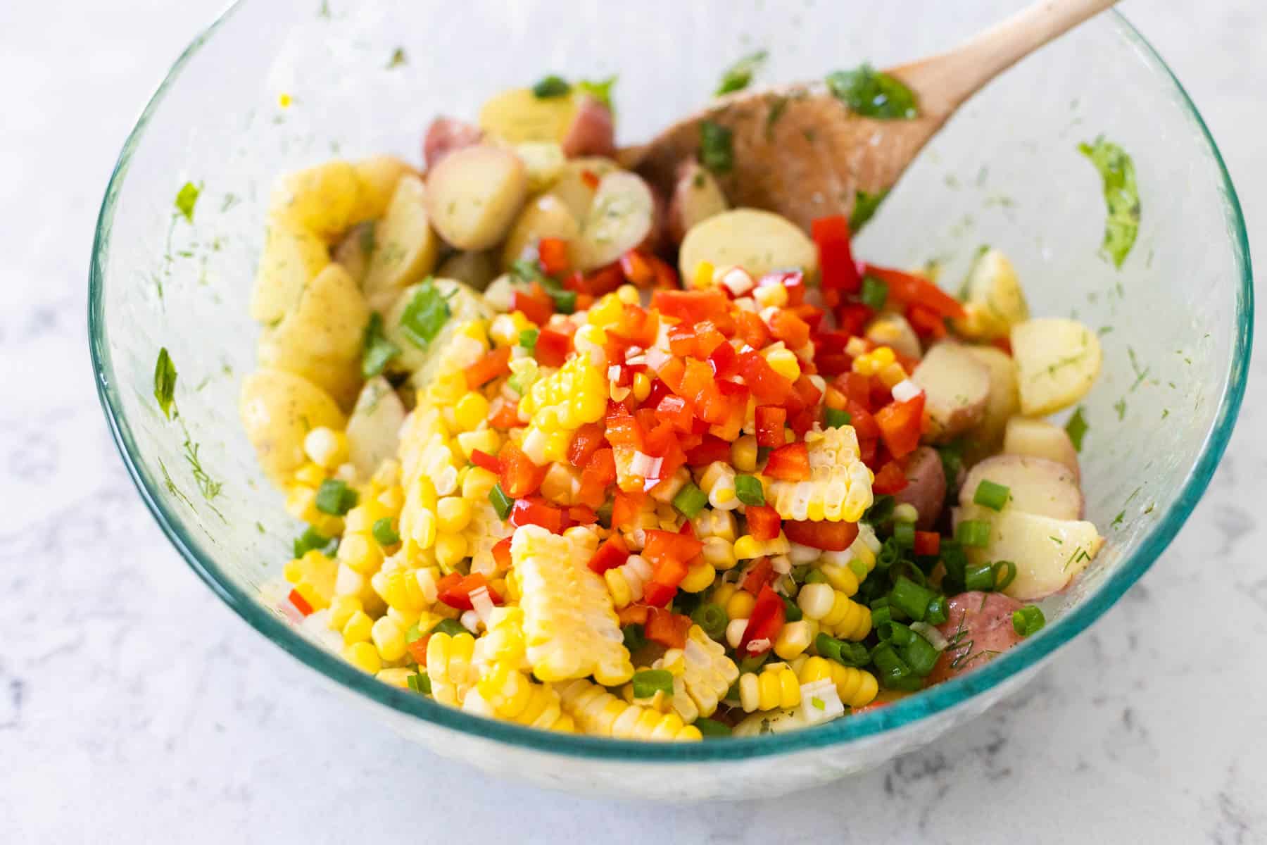 The fresh vegetables have been added to the mixing bowl.