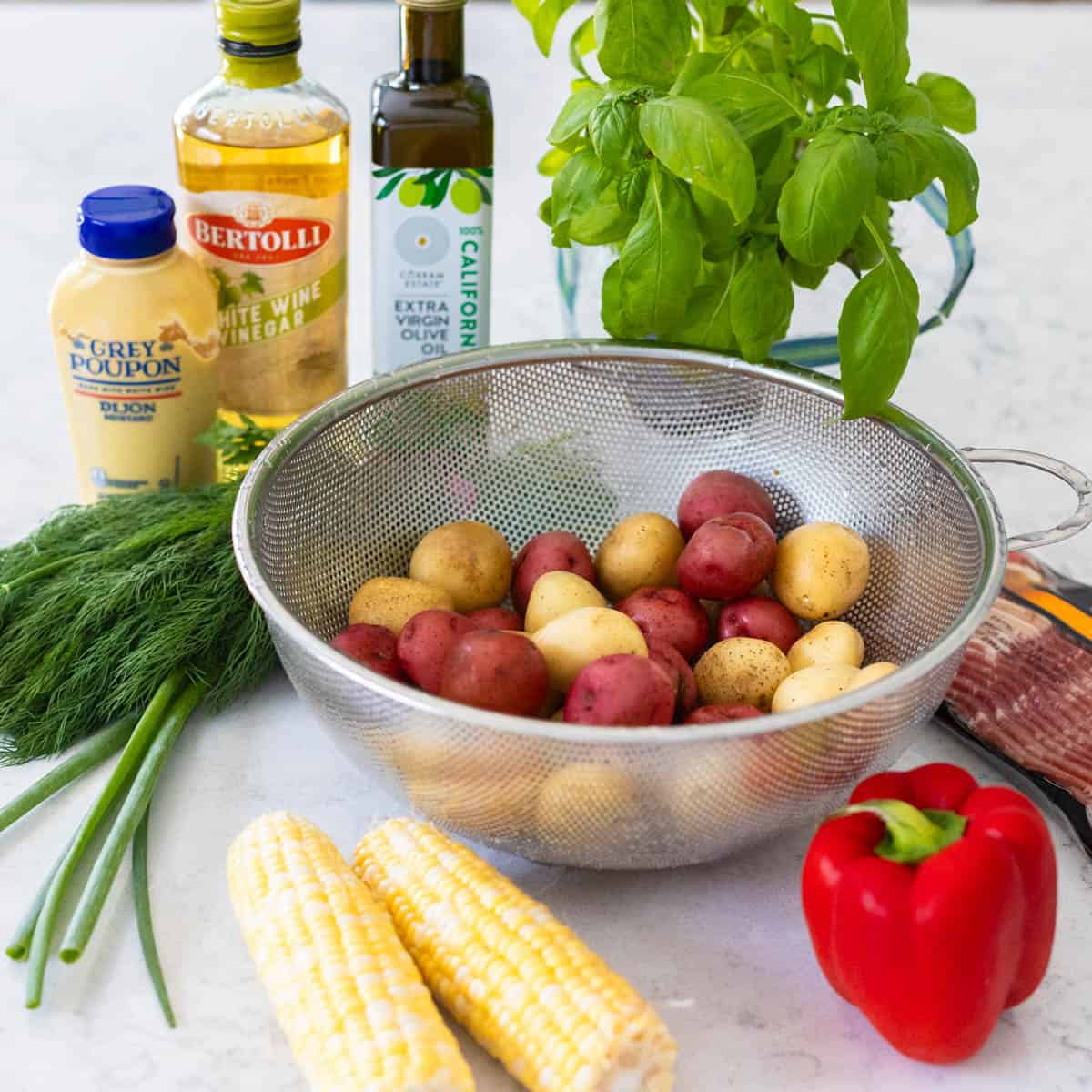 The ingredients to make the potato salad are on the counter.