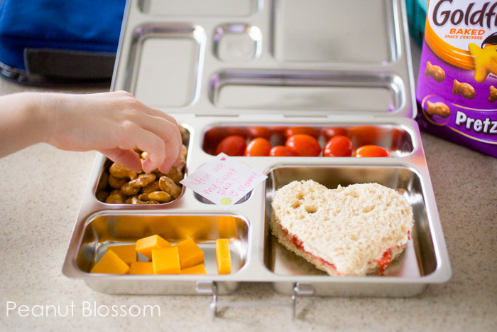 Bento box with kindergarten lunch ideas including goldfish crackers, cheese, and a heart-shaped sandwich