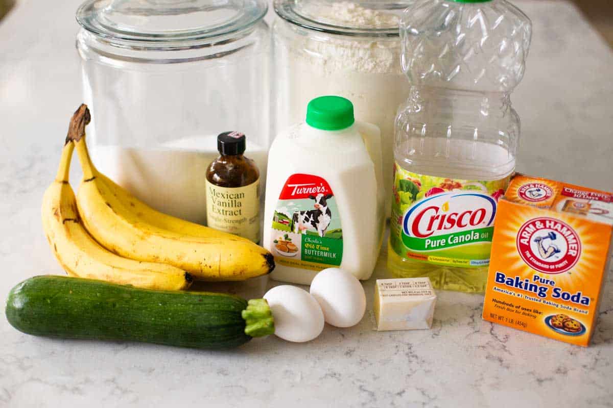 The ingredients for banana zucchini bread sit on a counter.