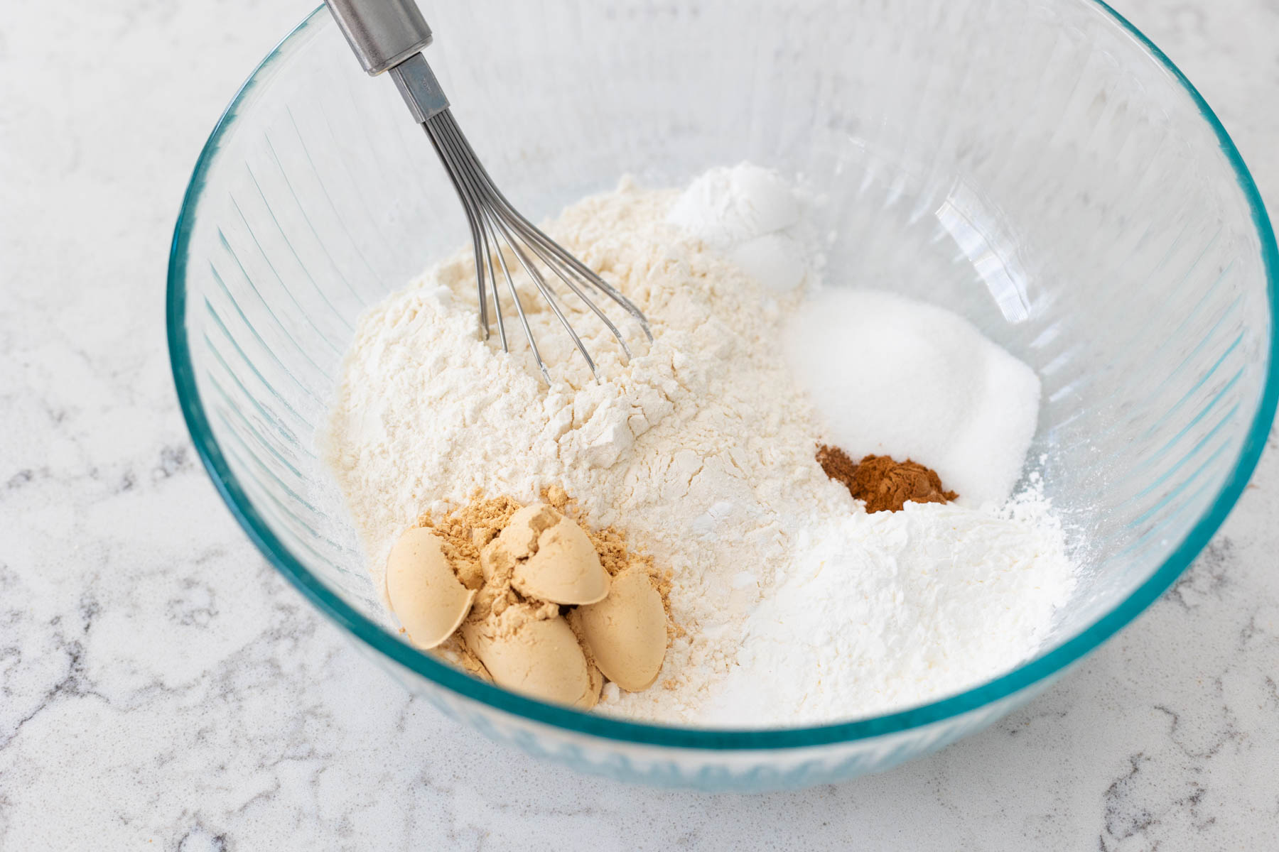 The flour, sugar, and peanut butter powder are in a large mixing bowl.