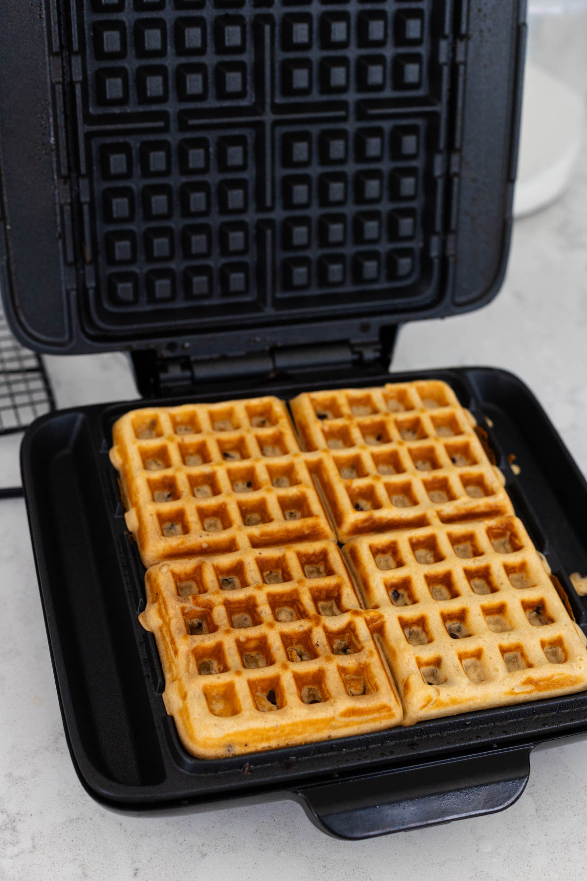 The peanut butter waffles have been fully cooked and are a gorgeous dark golden brown color.