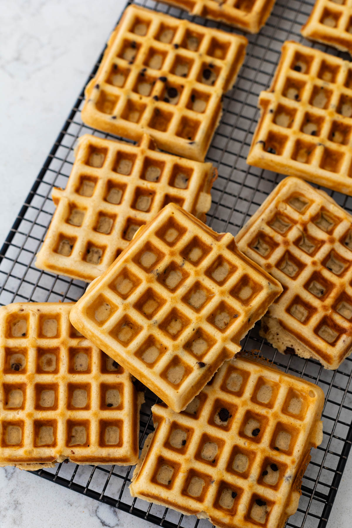 The chocolate chip waffles are cooling on the rack before freezing.