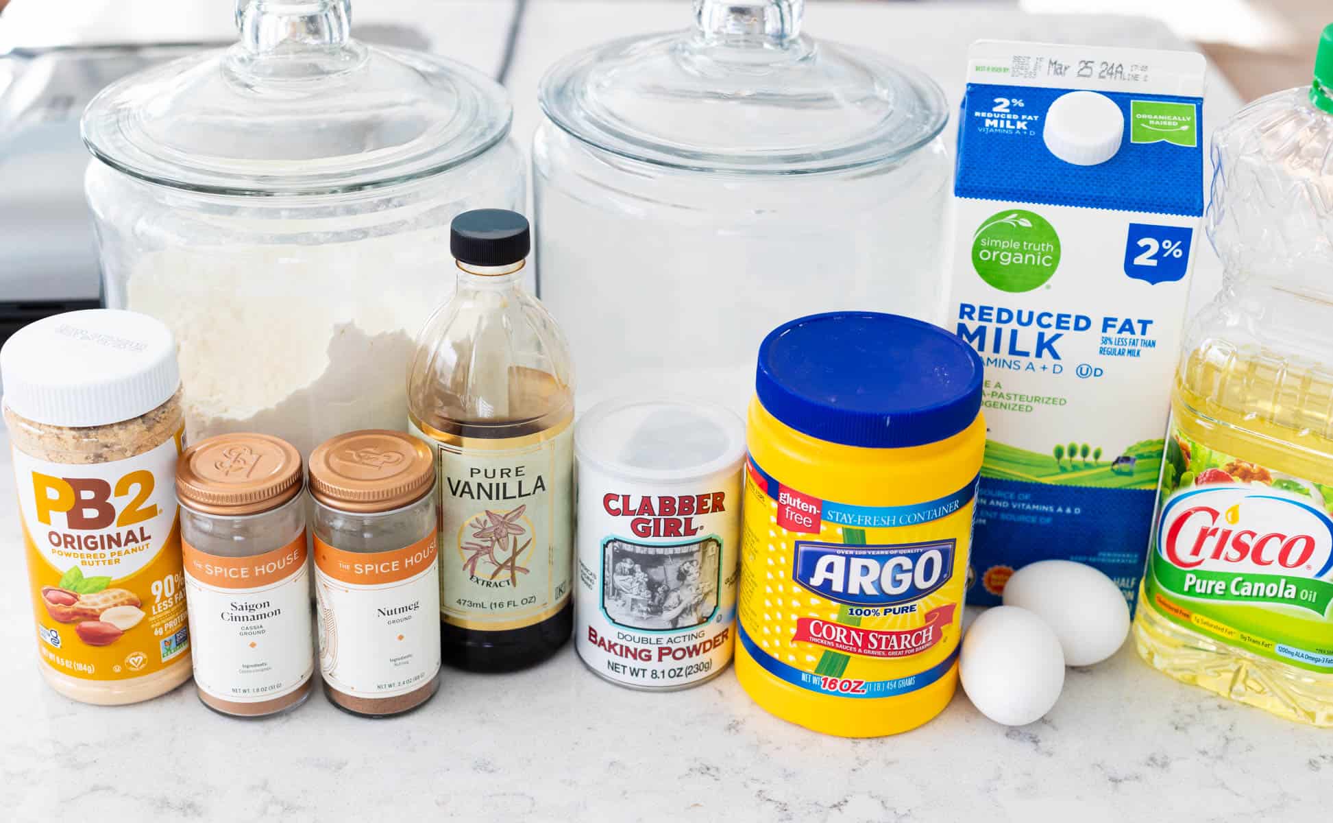 All the ingredients to make peanut butter waffles are on the counter.