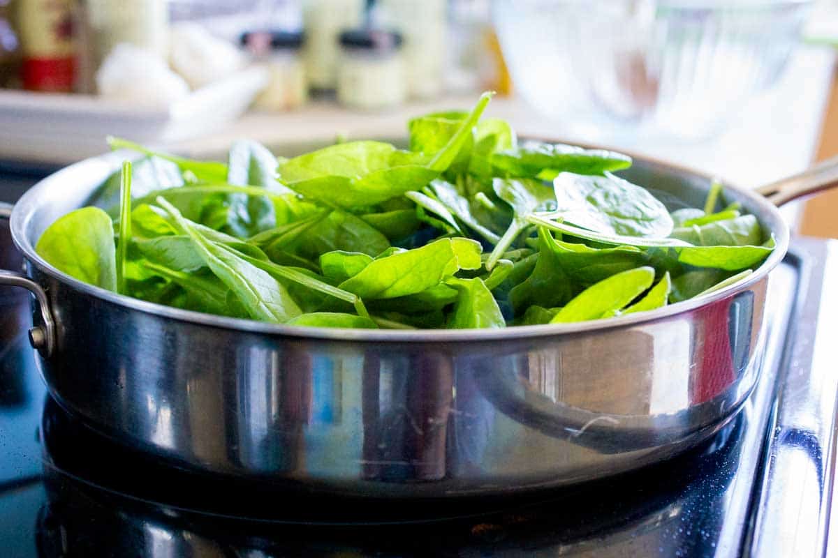 The pan is very full with baby spinach that will cook down.