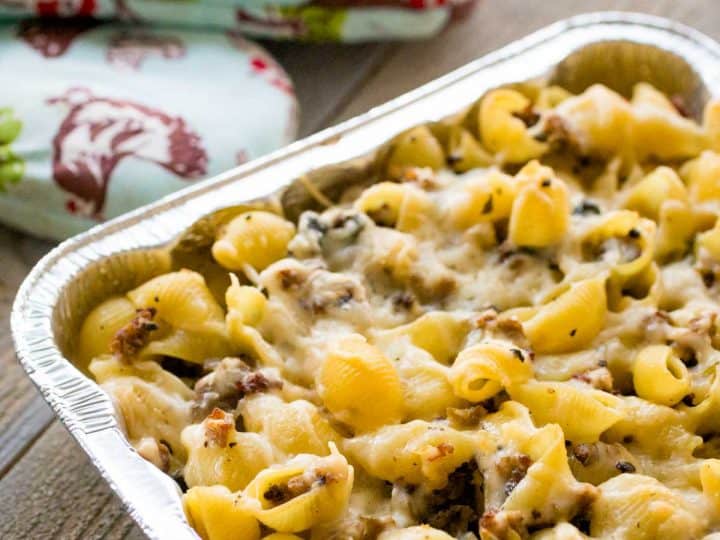 A metal pan filled with sausage and pasta casserole is ready to go into the freezer.