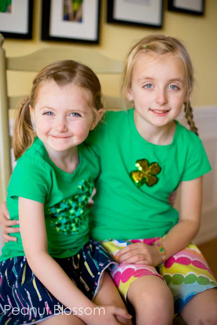 Two young girls wearing St. Patrick's Day t-shirts.