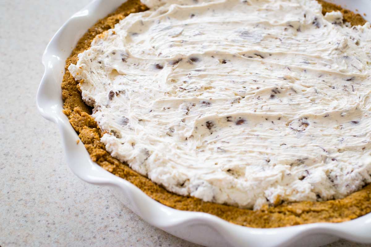 The creamy filling has been smoothed over the graham cracker crust.