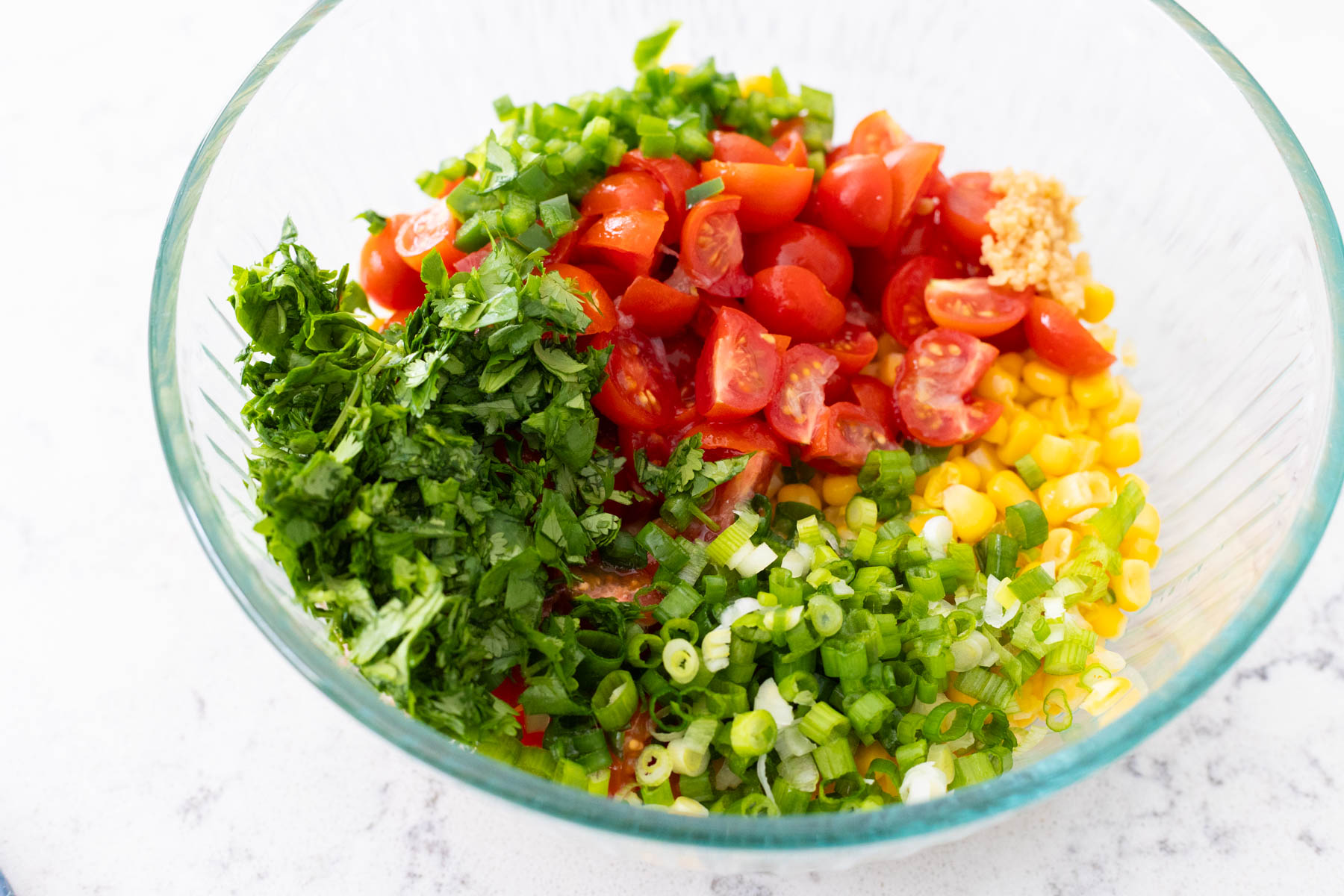 The prepped veggies are arranged in a large mixing bowl.