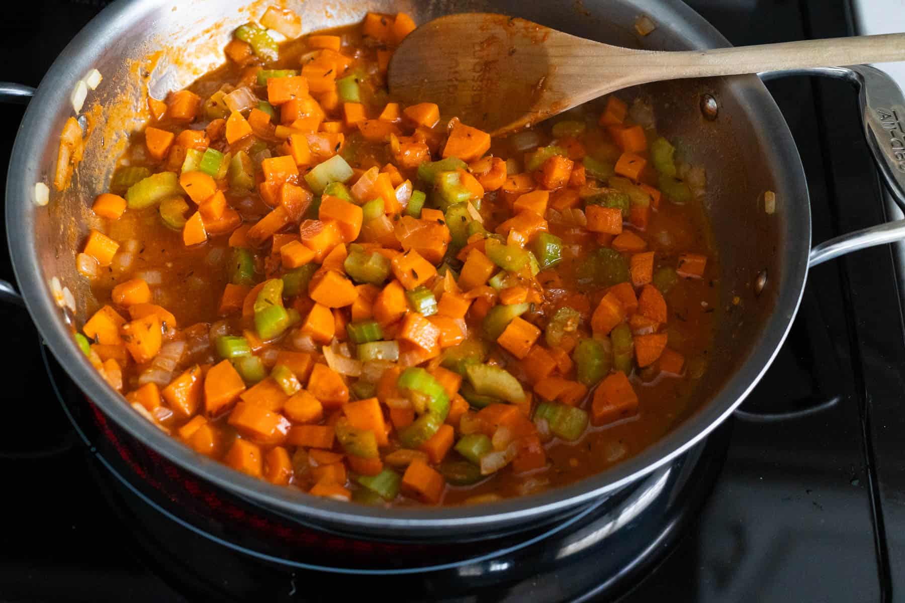 The chicken stock has been added to the skillet to scrape up the browned bits on the bottom of the veggies.