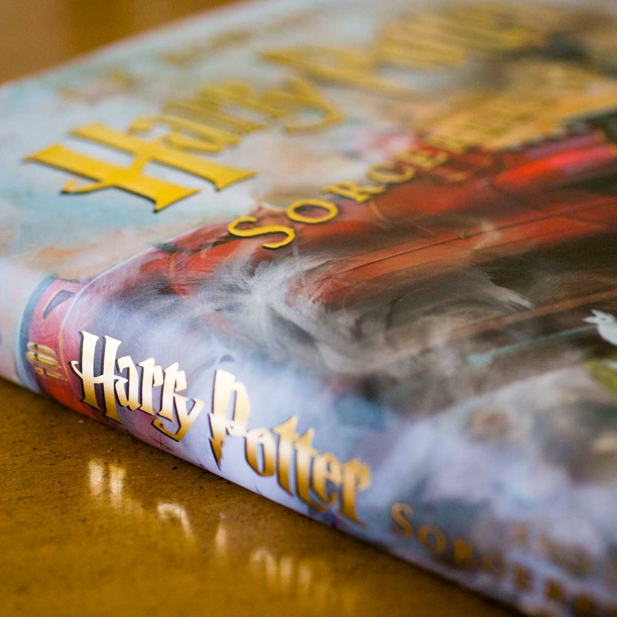 A copy of the illustrated Harry Potter book is on the table.